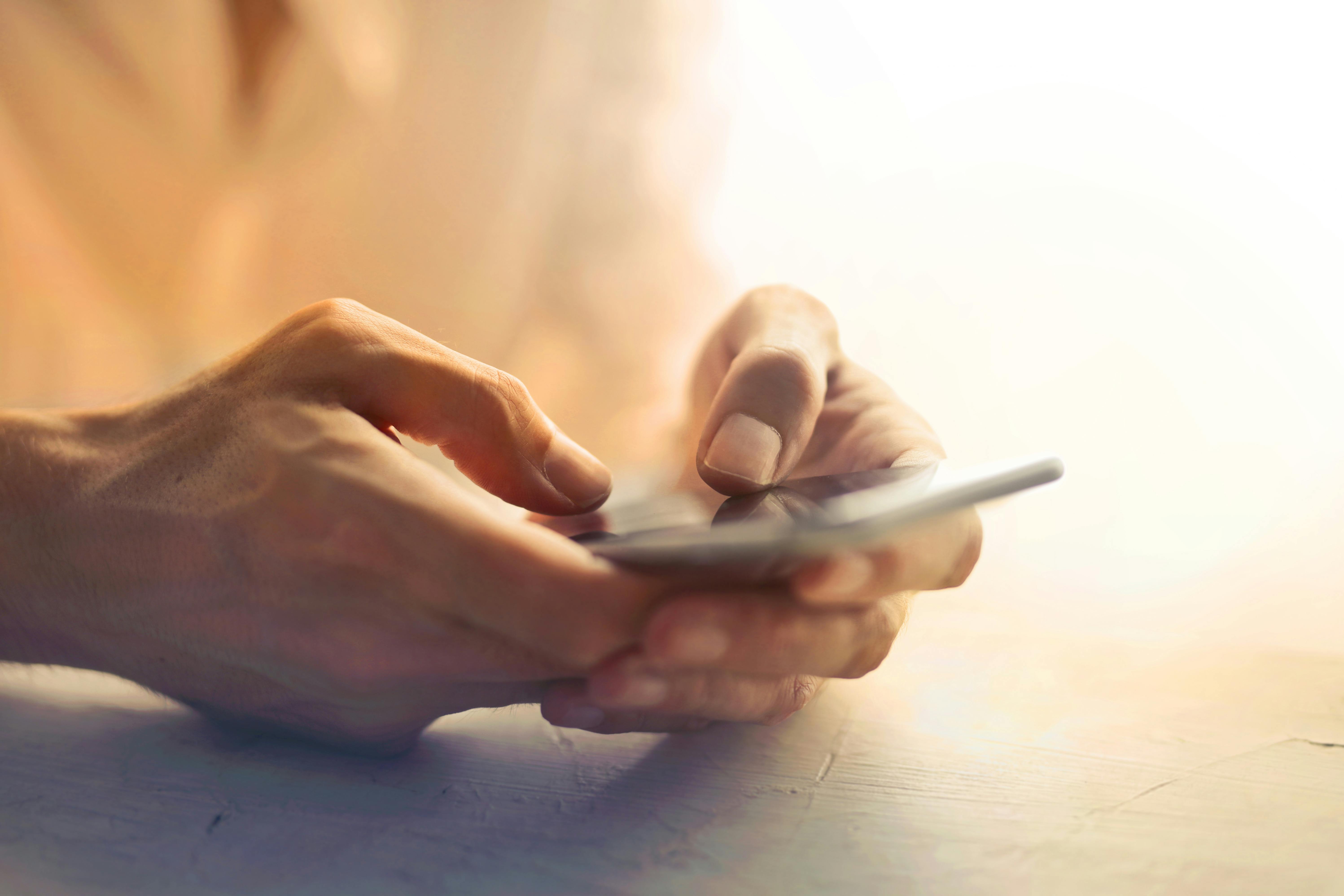 A person holding a phone in hands | Source: Pexels