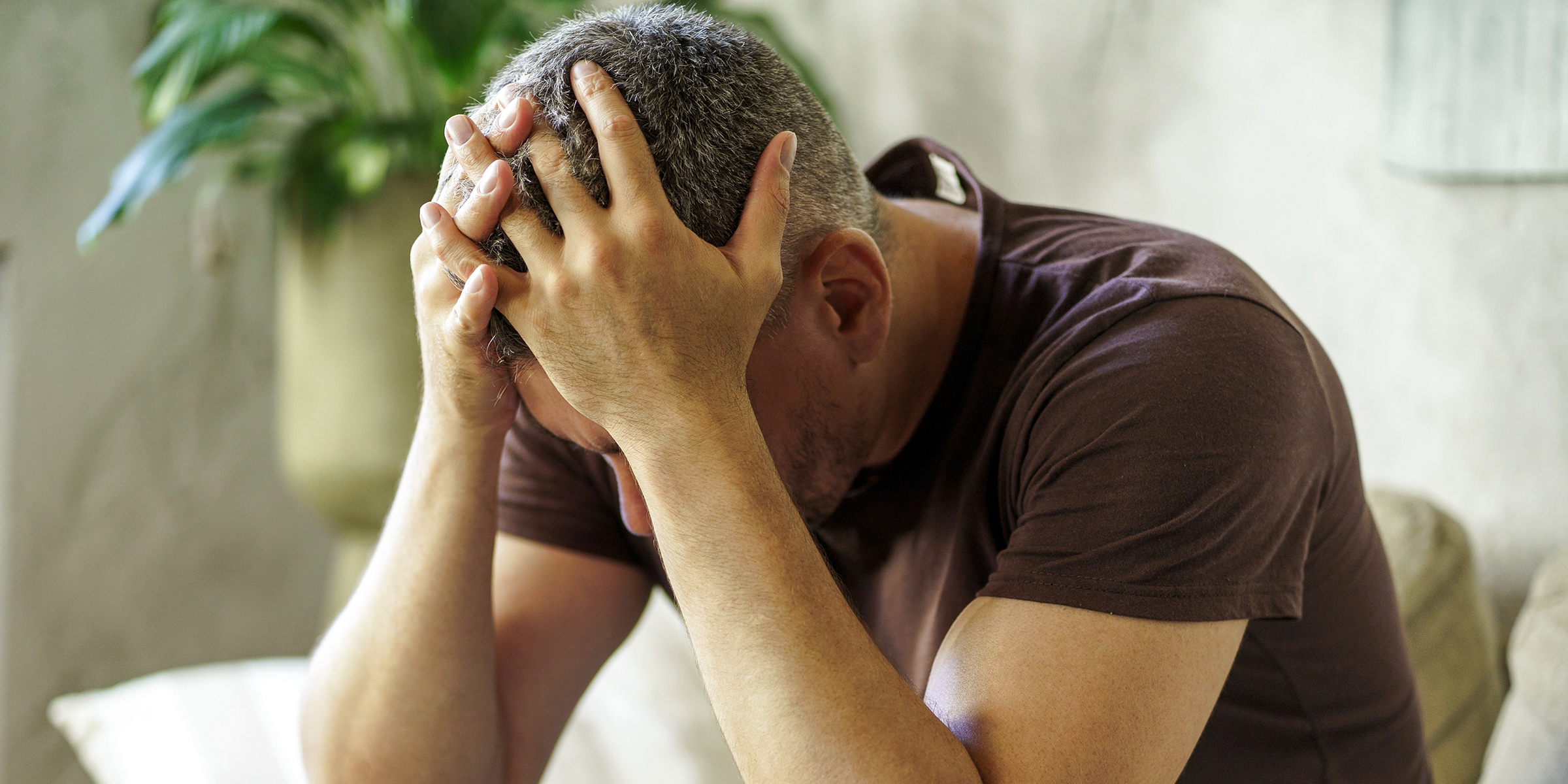 A man with his head in his hands | Source: Shutterstock