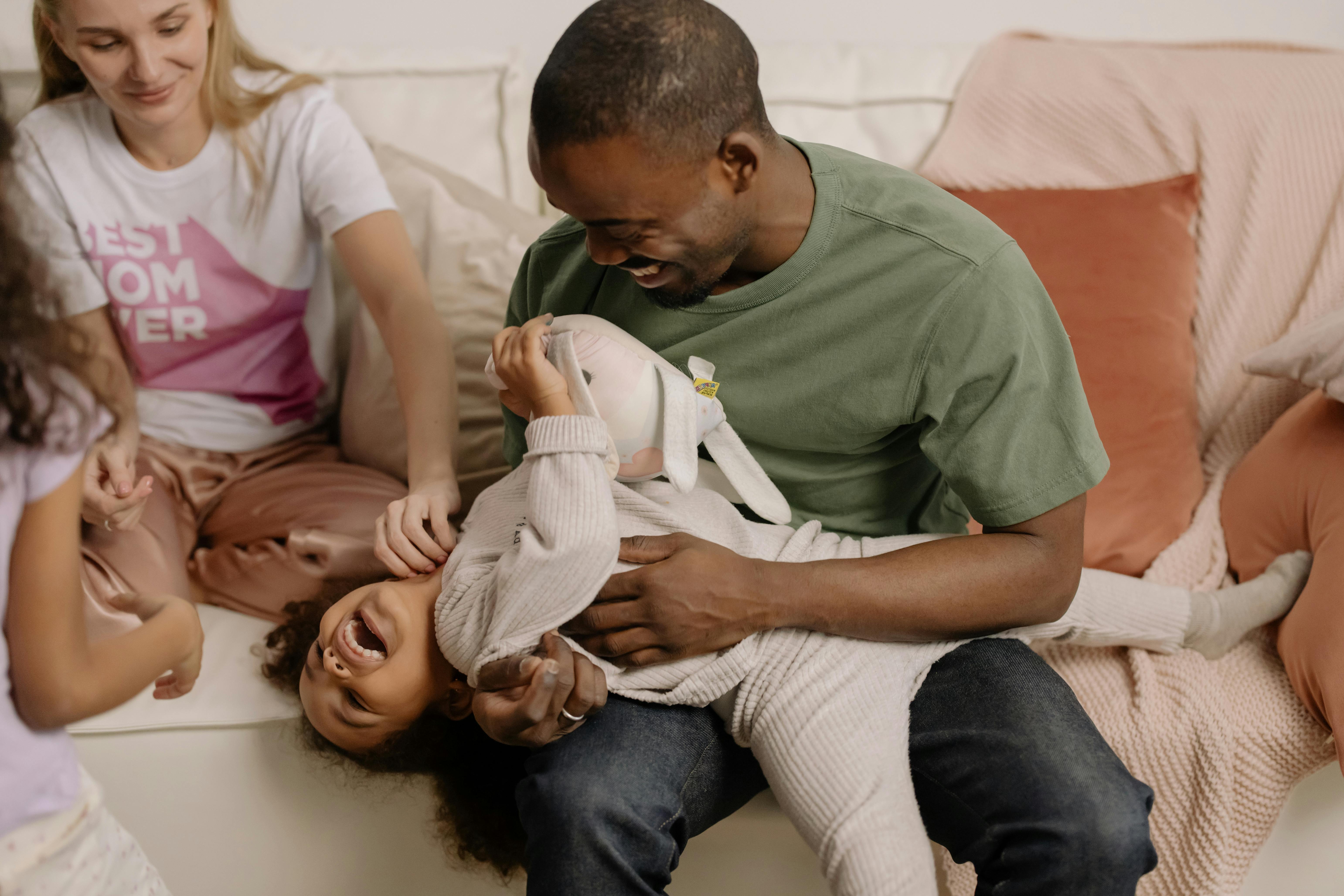 A man and his wife playing with their daughters | Source: Pexels