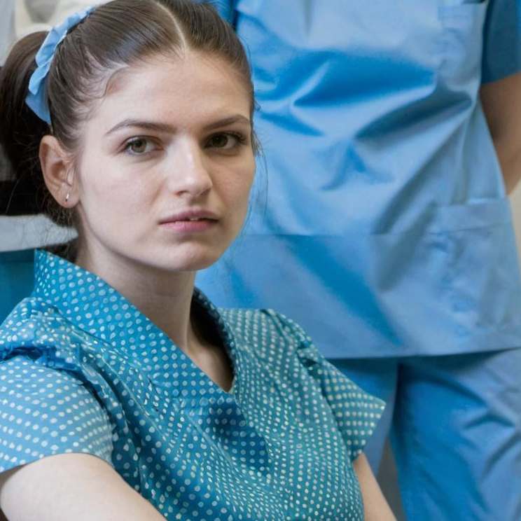 A woman in a wheelchair in the hospital | Source: Midjourney