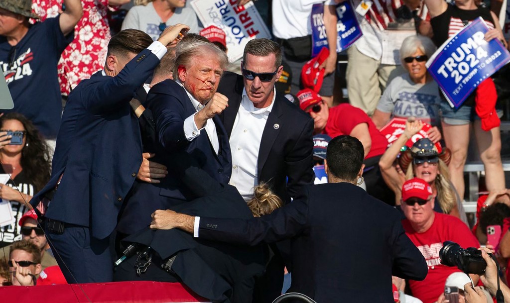 Republican candidate Donald Trump is seen with blood on his face moments after an attempt on his life.