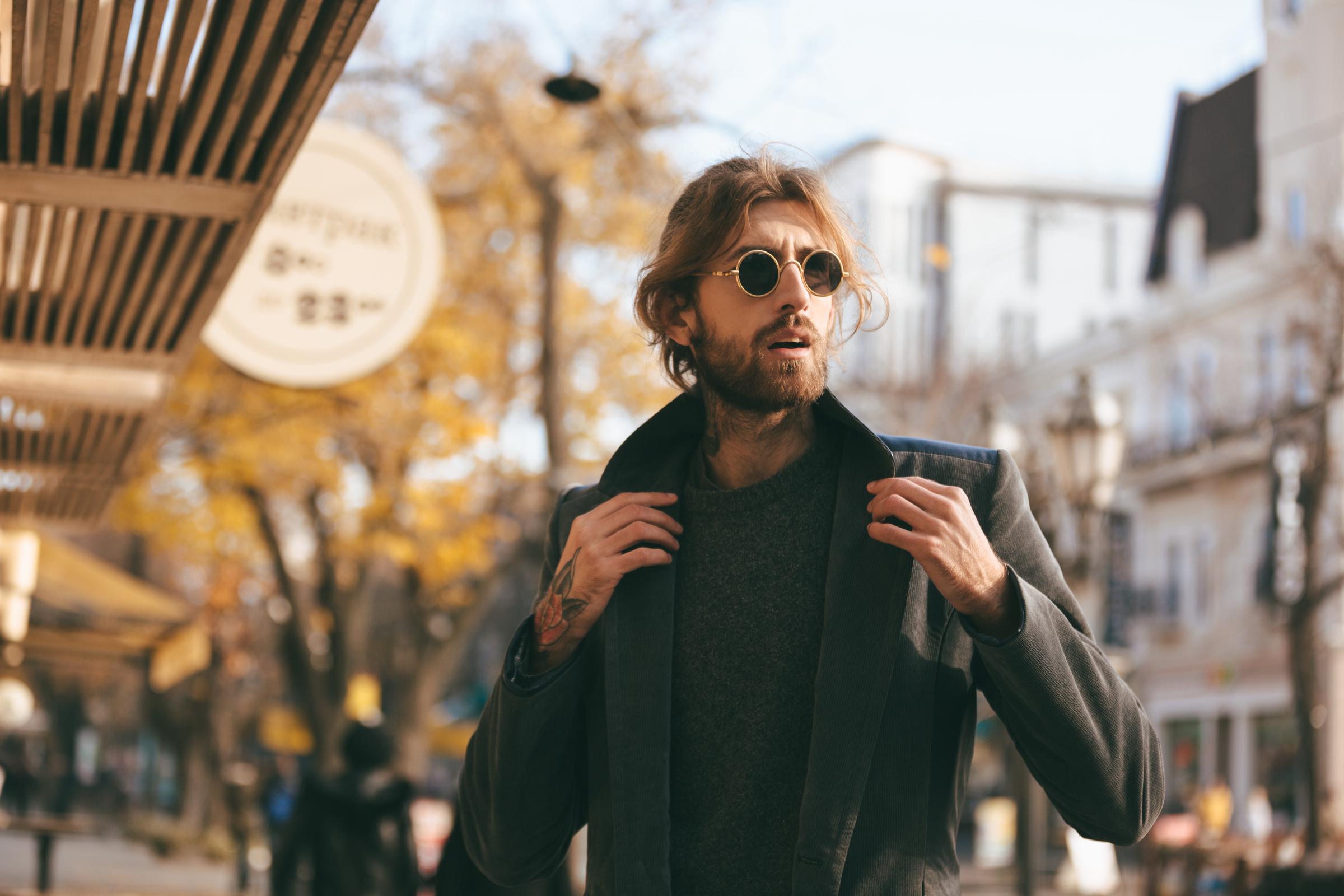 A handsome man in sunglasses and coat | Source: Freepik