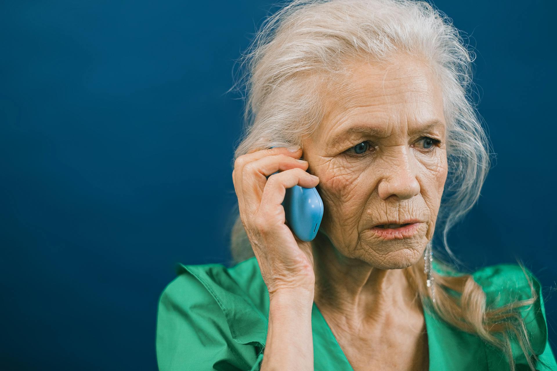 An older woman talking on the phone | Source: Pexels