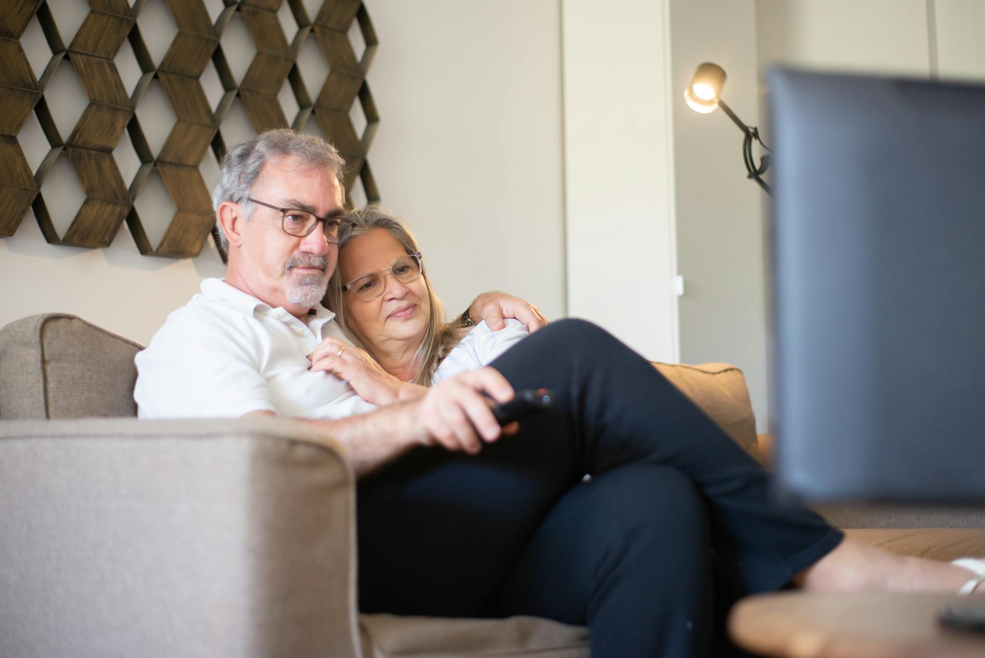 A mature couple seated on a sofa | Source: Pexels