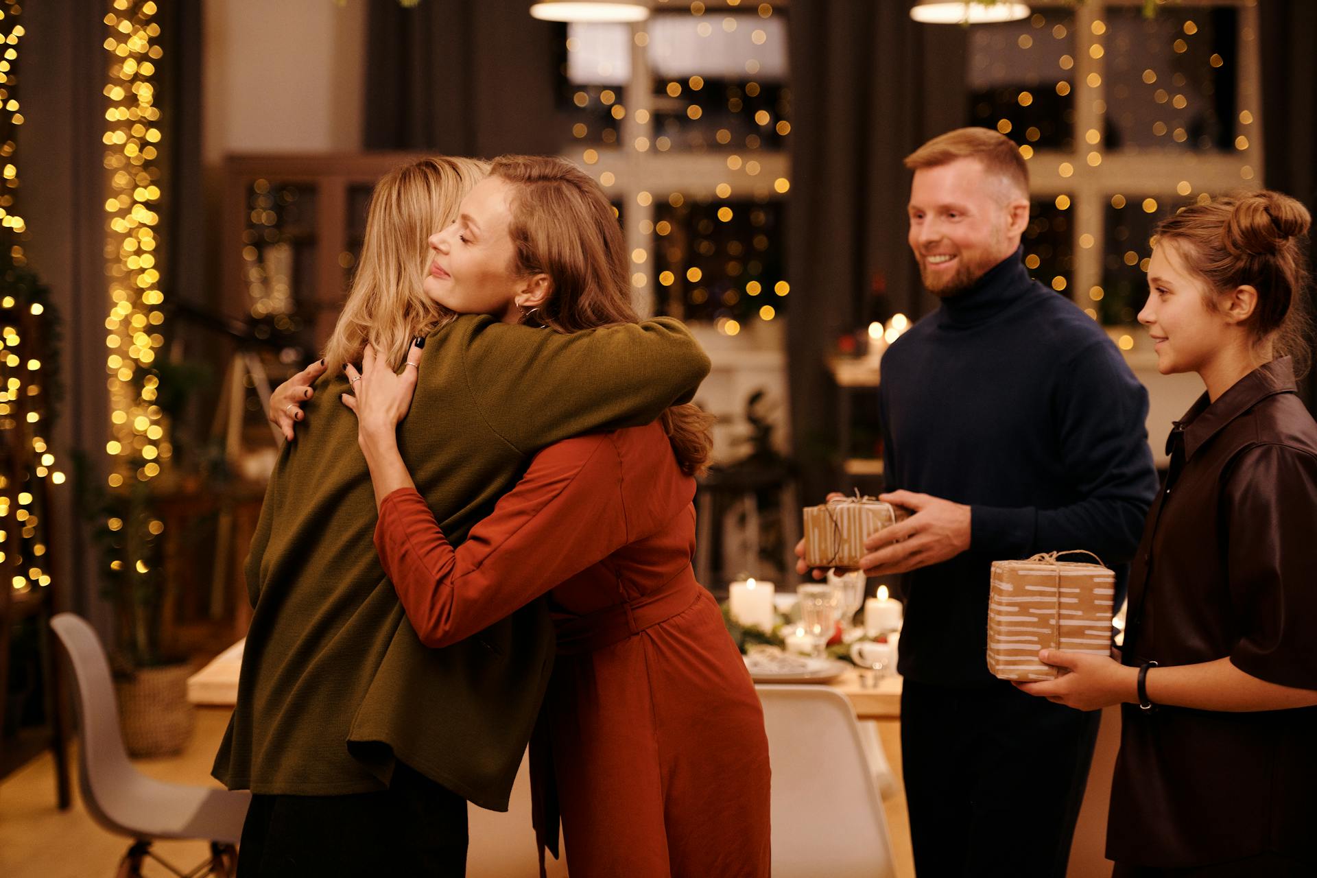 Two women hugging at a family dinner | Source: Pexels