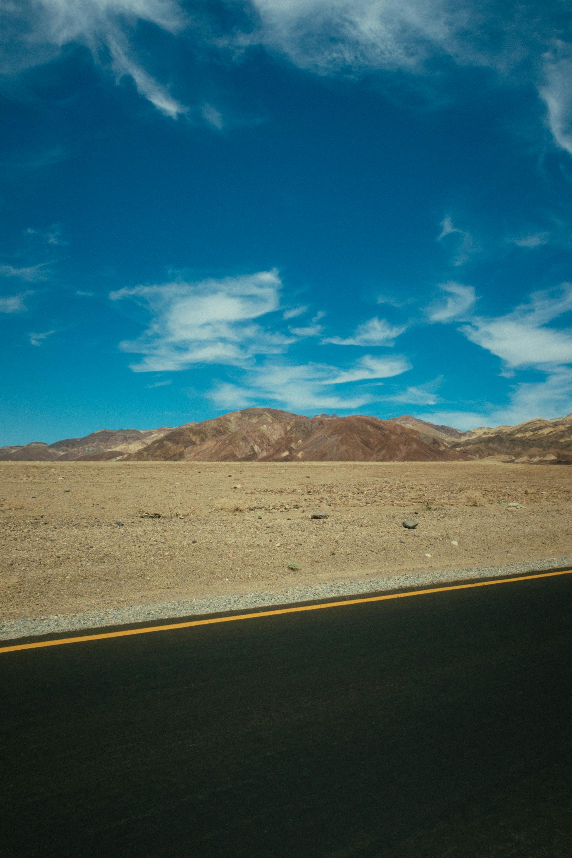 Barren fields next to a road | Source: Pexels