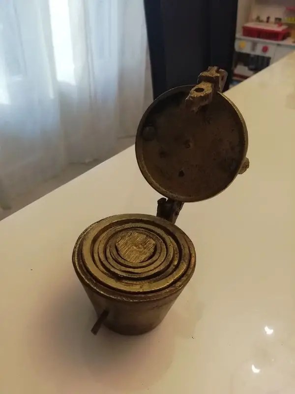 Little brass cups that fit inside each other and latch closed. Any idea